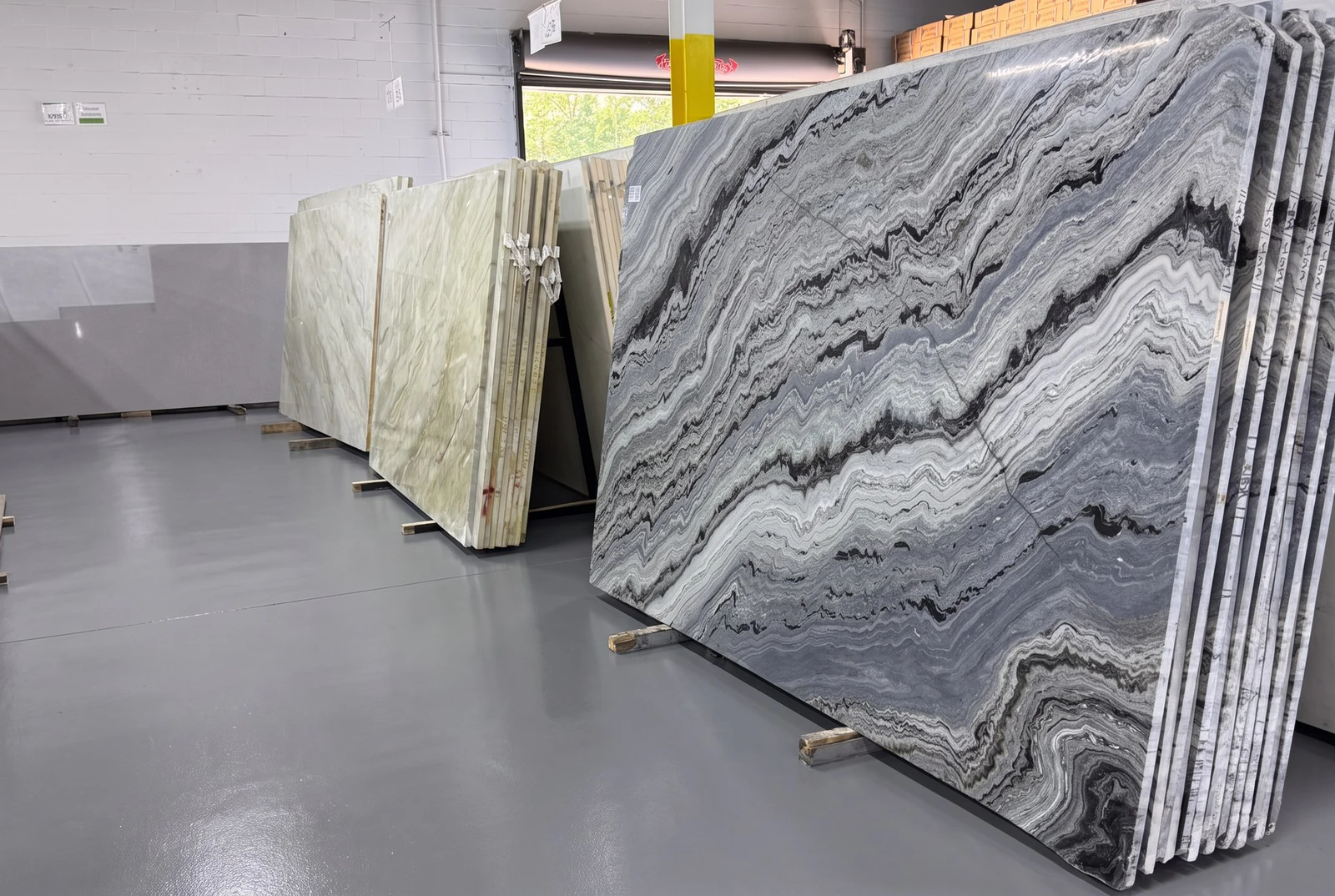 GA Granite slab warehouse with full quartzite and marble slabs standing on racks