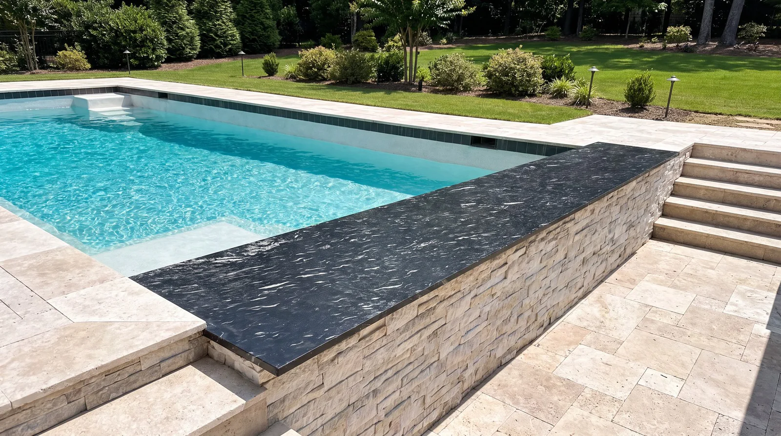 Black granite bar top along the edge of a new pool