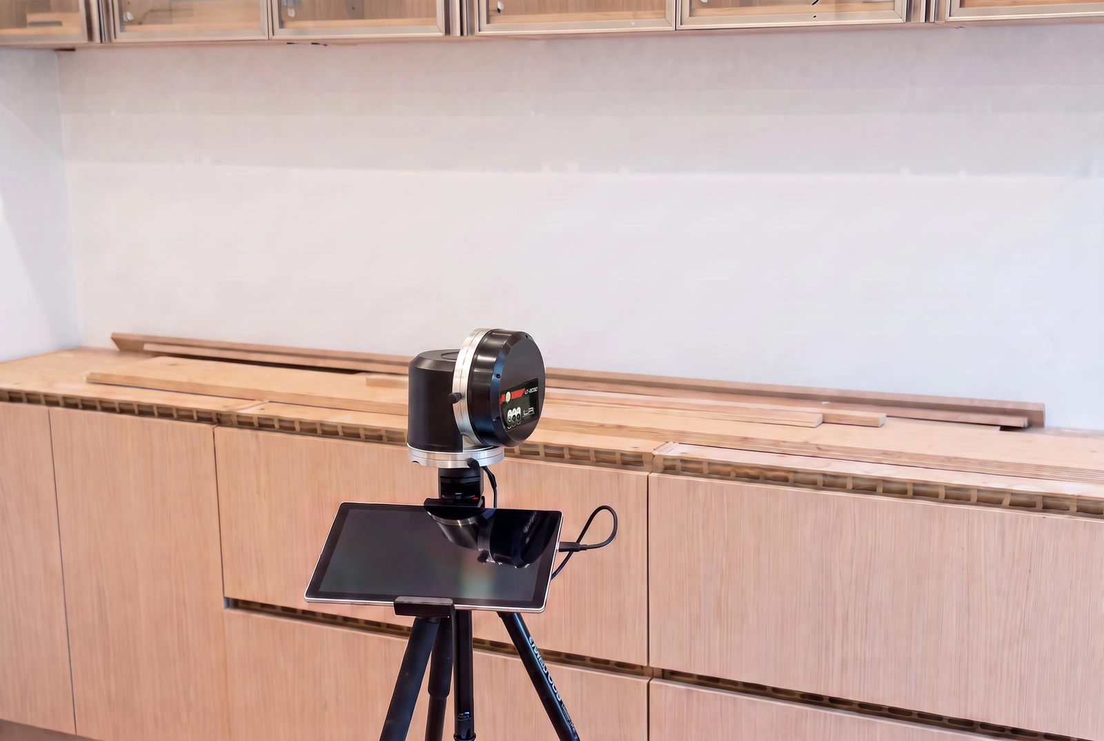 LPI LT-2030 laser templator and tablet on a tripod templating countertops over new base cabinets