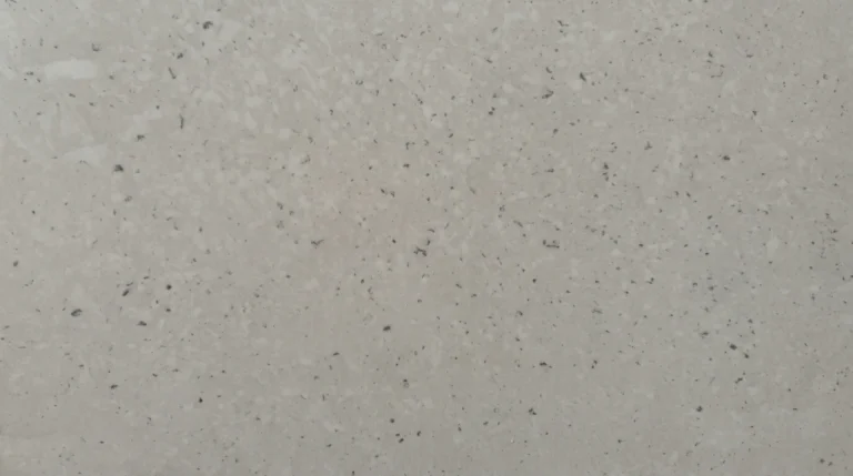 Polished Pinguino Blanca quartz slab, light warm gray with fine charcoal specks