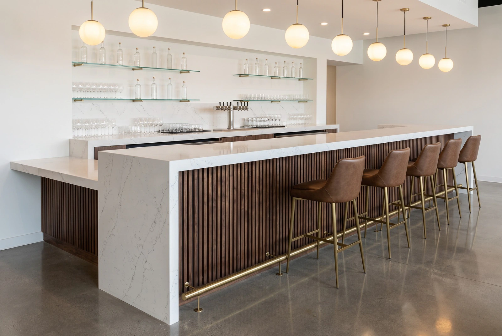 White quartz restaurant bar top with a mitered waterfall end and walnut slat bar front