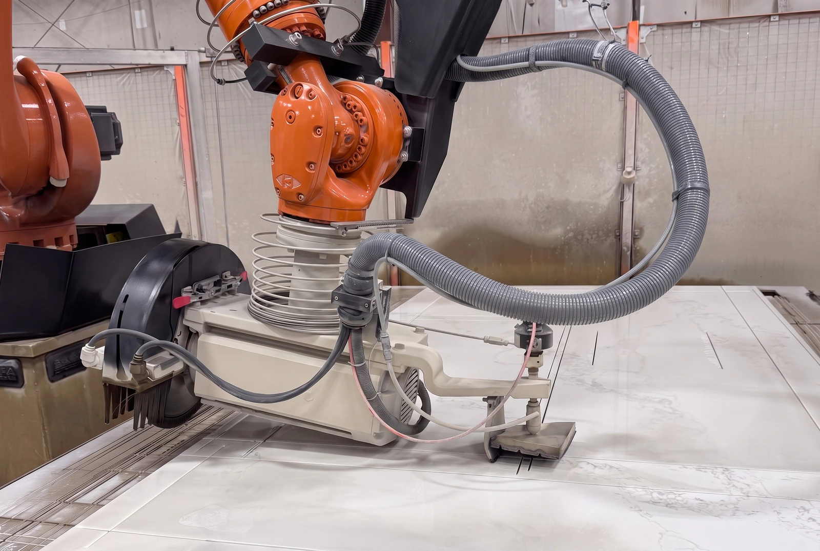 Robotic bridge saw cutting a white quartz slab into countertop pieces in the GA Granite shop